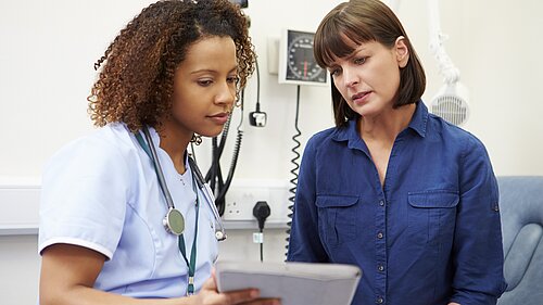 Two nurses looking at results.